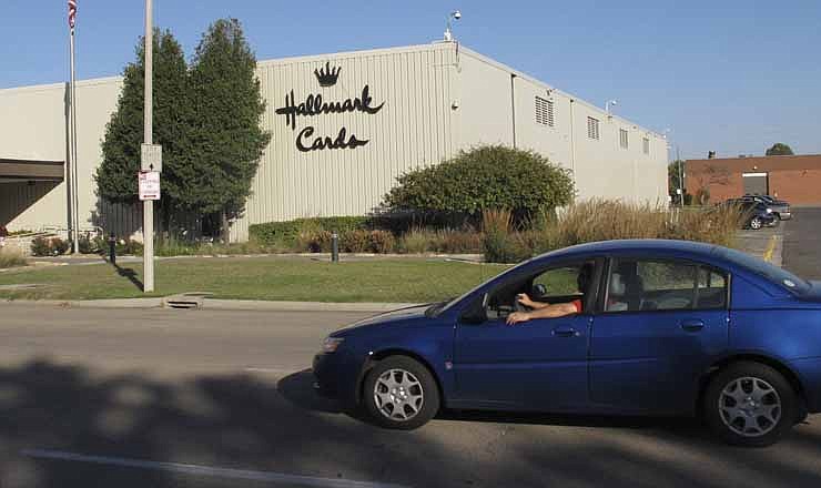 A car moves past the Hallmark Cards Inc. plant in Topeka, Kan., Tuesday, Oct. 2, 2012. The company says it plans to close the plant by the end of 2013.