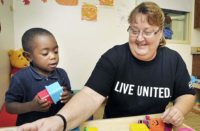 Lori Massman, this year's United Way Fund Drive co-chair, plays with Darren Howard from United Way agency Jefferson City Day Care.