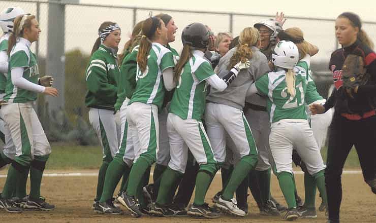 Members of the Blair Oaks Lady Falcons congratulate Amy Dorge for her game winning hit in Saturday's Class 3 District 10 championship game in Wardsville, Mo.