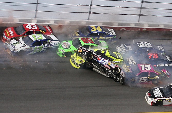 Tony Stewart (14) flips over as Clint Bowyer (15), Regan Smith (78), Jeff Burton (31), Jimmie Johnson (48), Casey Mears (13), Aric Almirola (43), Dale Earnhardt Jr. (88) and David Ragan (34) crash around him during the Good Sam Roadside Assistance 500 on Sunday at Talladega Superspeedway in Talladega, Ala.