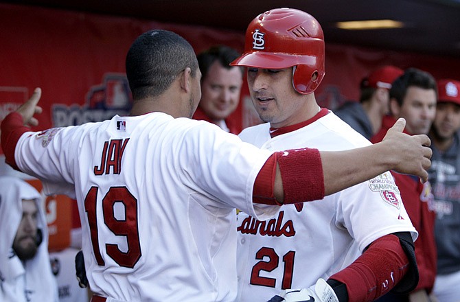 Allen Craig (right) gets a hug from Cardinal teammate Jon Jay after hitting a solo home run in the third inning of Monday's game against the Nationals at Busch Stadium.