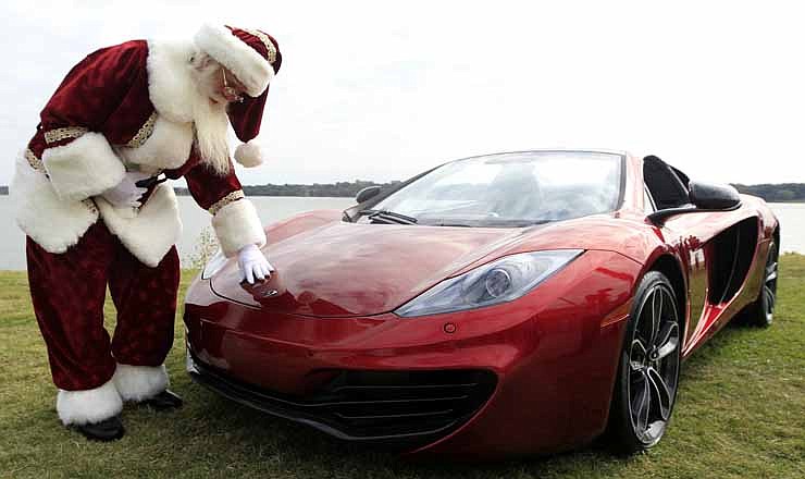 Brady White portrays Santa Clause as he shows off a 2013 McLaren 12C spider sports car during the unveiling of the Neiman Marcus 2012 Christmas Book in Dallas, Tuesday, Oct. 9, 2012. The Neiman Marcus edition is one of 12 made and priced at $354,000. 