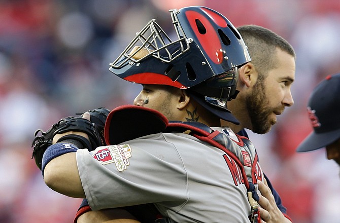 Cardinals starting pitcher Chris Carpenter hugs catcher Yadier Molina after Game 3 of the National League division series Wednesday in Washington.