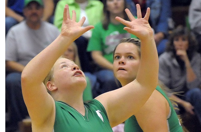 Danielle Lueckenhoff of Blair Oaks prepares to set as teammate Riley Butler looks on during Thursday's game against Rock Bridge at the Blair Oaks gym. The Lady Falcons swept the Lady Bruins.