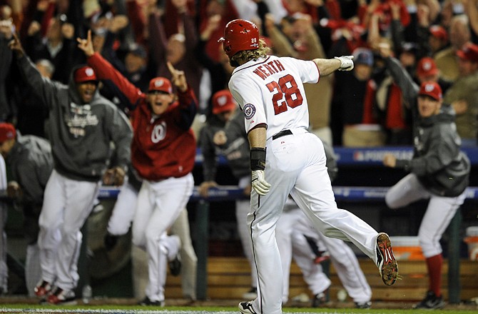 The Nationals' Jayson Werth points to the Nationals' dugout as he rounds the bases after hitting the game-winning home run in the ninth inning of Thursday's National League division series against the Cardinals. The series is tied at 2, with Game 5 scheduled for tonight in Washington.