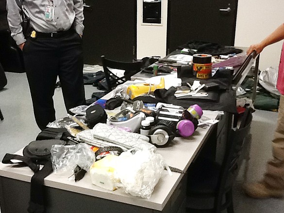 This image provided by the Los Angeles Police Department shows officials seizing material from the luggage of Yongda Huang Harris after he attempted to enter the United States at Los Angeles International Airport. 