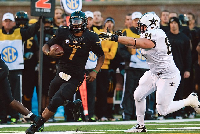 Missouri quarterback James Franklin (left) runs away from the grasp of Vanderbilt defensive tackle Rob Lohr during the first quarter Oct. 6 in Columbia. Franklin will not play today.