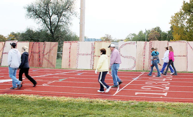 Participants make their way around the Missouri School for the Deaf track during CARDV's first Light the Night event on Friday. The organization's goal was to have 1,044 miles logged - one for each client served in 2011.