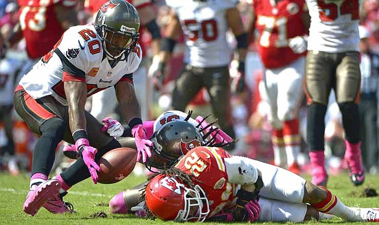 Tampa Bay Buccaneers free safety Ronde Barber (20) scoops up a pass for an interception beside Kansas City Chiefs wide receiver Dexter McCluster (22) before running it back for a 78-yard touchdown during the second half of an NFL football game on Sunday, Oct. 14, 2012, in Tampa, Fla. 