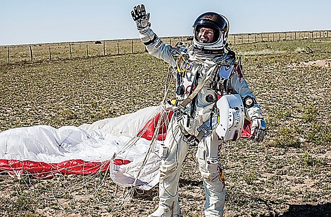 Pilot Felix Baumgartner of Austria celebrates after jumping from his capsule 128,097 feet, or 24 miles, above Earth.