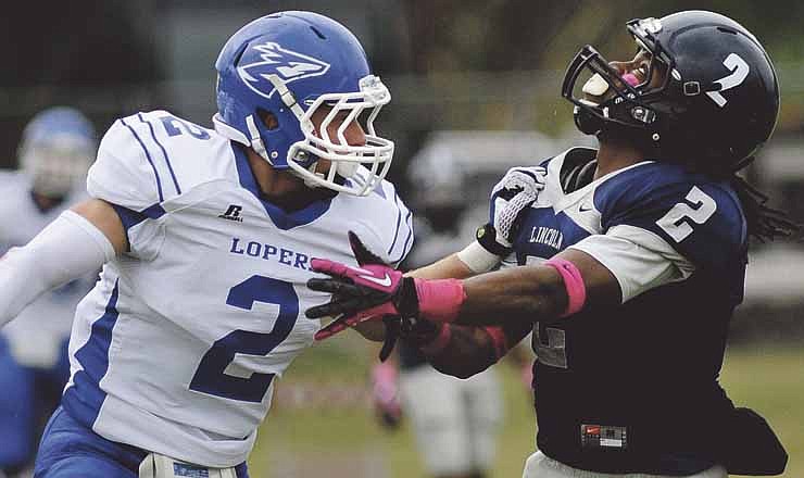 Morris Henderson of Lincoln and Ryan Lendrum of Nebraska-Kearney battle while waiting for a pass to come down during Saturday's game at Dwight T. Reed Stadium. 