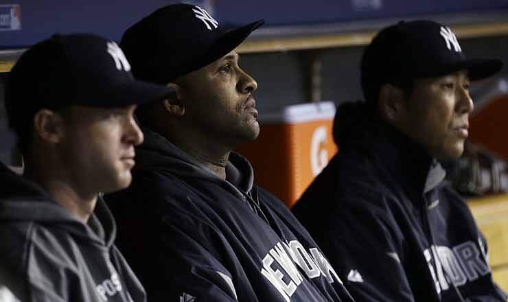 New York Yankees' CC Sabathia, middle, watches during the sixth inning in Game 3 of the American League championship series against the Detroit Tigers Tuesday, Oct. 16, 2012, in Detroit. 