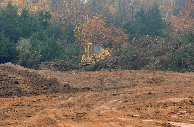 Heavy equipment operators are working to prepare the site behind 136 N. Greenway in Holts Summit for construction of a new headquarters facility for Pro Food Systems.
