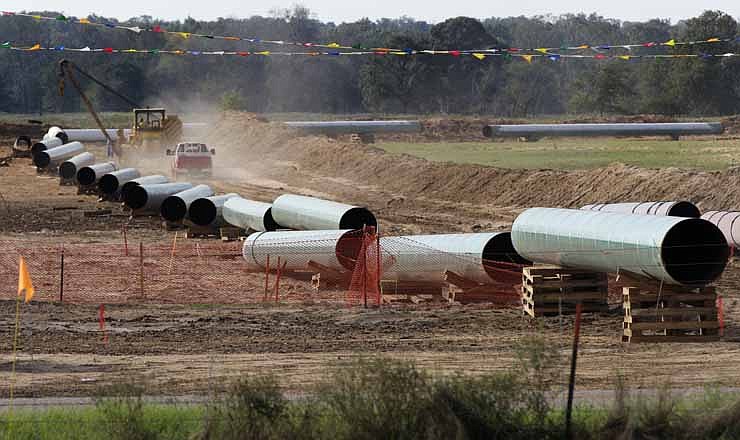 Large sections of pipe are shown on a neighboring property to Julia Trigg Crawford family farm Thursday, Oct. 4, 2012, in Sumner Texas. Oil has long lived in harmony with farmland and cattle across the Texas landscape, a symbiosis nurtured by generations and built on an unspoken honor code that allowed agriculture to thrive while oil was extracted.