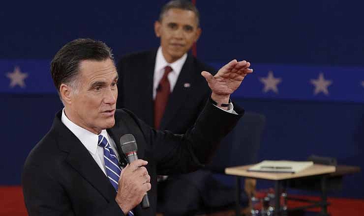 President Barack Obama listens as Republican presidential nominee Mitt Romney speaks during the second presidential debate at Hofstra University, Tuesday, Oct. 16, 2012, in Hempstead, N.Y.