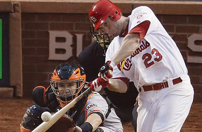 The Cardinals' David Freese hits a double during Game 3 of Wednesday's National League championship series at Busch Stadium in St. Louis. The Cardinals won 3-1.