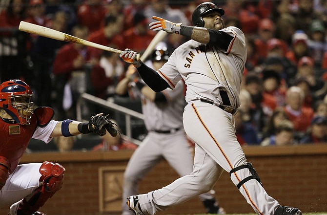 The Giants' Pablo Sandoval hits a home run during the eighth inning of Game 5 of the NLCS against the Cardinals.