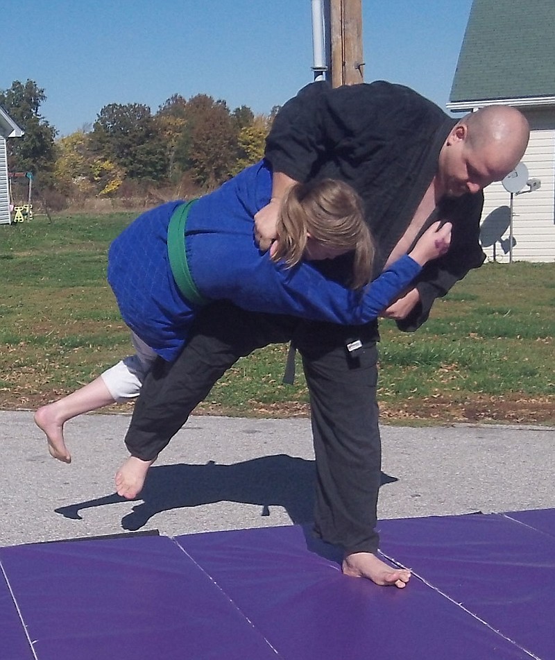 Chris Heitmann tosses his daughter and assistant coach, DeAnna, during judo practice. Heitmann will be opening DDD Judo Mid Mo, a judo club in Auxvasse, in November.