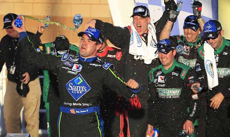 Driver Ricky Stenhouse Jr. celebrates in victory lane after winning a NASCAR Nationwide Series auto race at Kansas Speedway in Kansas City, Kan., Saturday, Oct. 20, 2012.