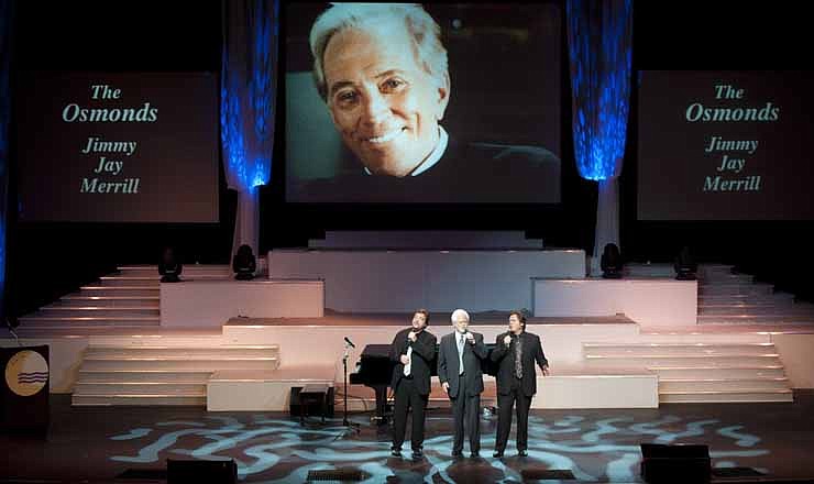 From left, Jay Osmond, Merrill Osmond, and Jimmy Osmond sing at Andy Williams' memorial service at the Moon River Theater, in Branson, Mo., Sunday, Oct. 21, 2012. Williams, known for singing "Moon River" and his Christmas television specials, passed away Sept. 25. 