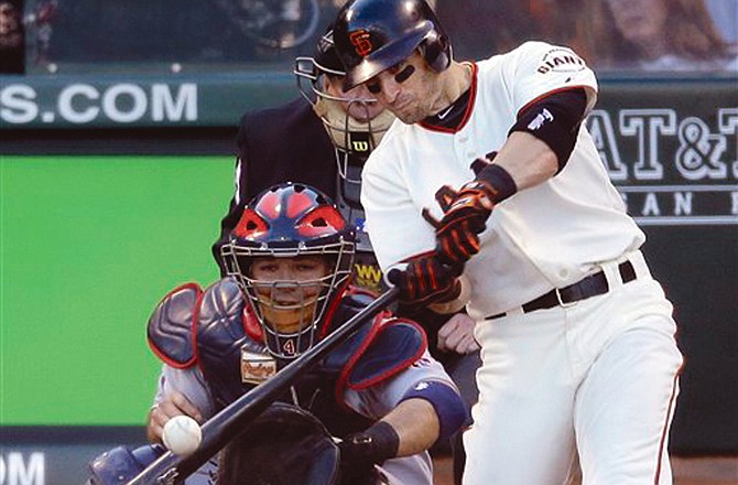 The Giants' Marco Scutaro hits a two-run double during the second inning of Game 6 of the National League championship series.