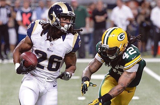 Rams running back Daryl Richardson looks for running room as Packers free safety Morgan Burnett defends during the fourth quarter of Sunday game in St. Louis.