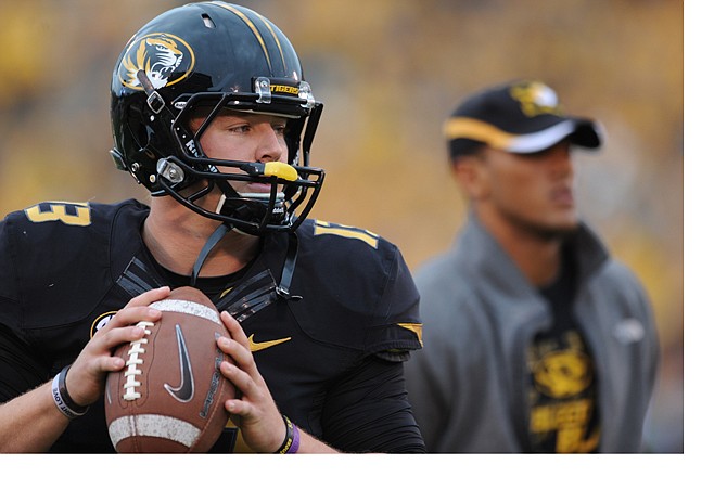 Missouri quarterback Corbin Berkstresser warms up as injured quarterback James Franklin stands by before the start of the game against Alabama earlier this month at Faurot Field.