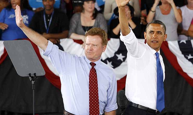  In this Sept, 27, 2012 file photo, President Barack Obama, accompanied by retiring Sen. Jim Webb, D-Va., left, waves to supporters during a campaign rally in Virginia Beach, Va. 