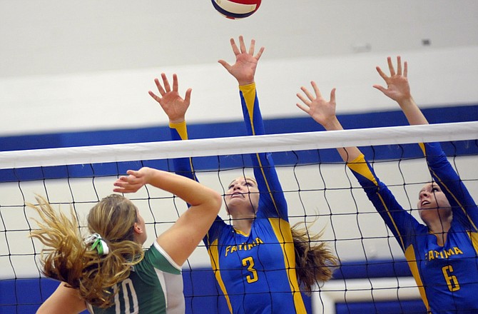 Fatima teammates JoAnna Muenks (3) and Morgan Bax (6) attempt to block a shot by Riley Butler of Blair Oaks during the Class 2 District  7 champioonship match Tuesday night in Russellville