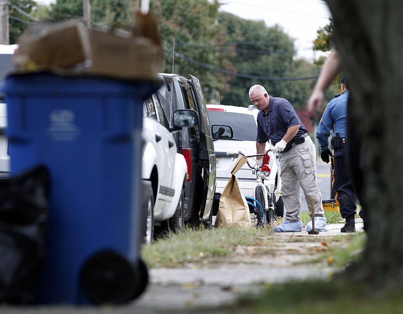 An investigator loads into a police van a BMX bicycle removed Tuesday in New Jersey from a house where the body of Autumn Pasquale was found in the home's backyard recycling bin. Authorities did not confirm the bike was the one belonging to Pasquale, but it matched the description of the one she was seen riding before she disappeared. 