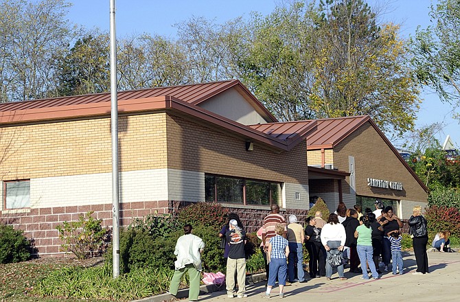 People wait for the Samaritan Center to open Wednesday morning, Oct. 24, 2012, on East McCarty Street. 