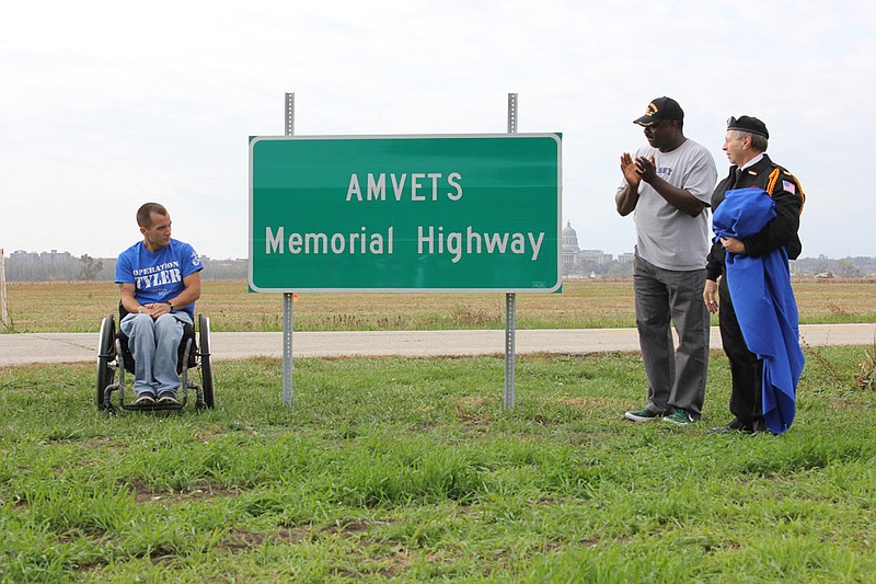 Tyler Huffman, Charles Williams and Albert Nichols unveil the sign officially declaring State Road 94 from Jefferson City to Portland as AMVETS Memorial Highway Thursday. The sign was unveiled in a morning ceremony after years of effort from AMVETS leader Bob Spencer.