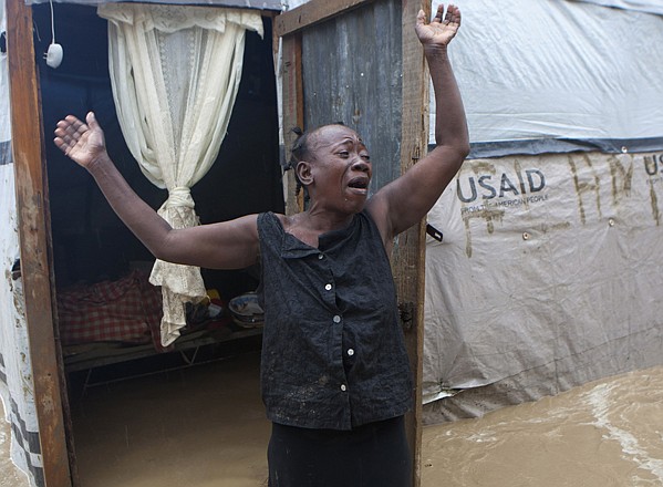 A woman cries out Thursday in front of her house, which was flooded after heavy rains from Hurricane Sandy in Port-au-Prince, Haiti. Hurricane Sandy rumbled across mountainous eastern Cuba and headed toward the Bahamas on Thursday as a Category 2 storm, bringing heavy rains and blistering winds. 