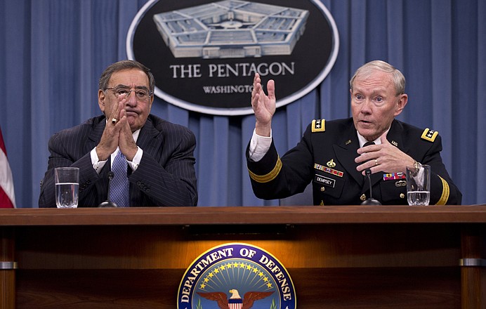 Joint Chiefs Chairman Gen. Martin Dempsey, right, accompanied by Defense Secretary Leon Panetta, gestures during their joint news conference Thursday at the Pentagon.