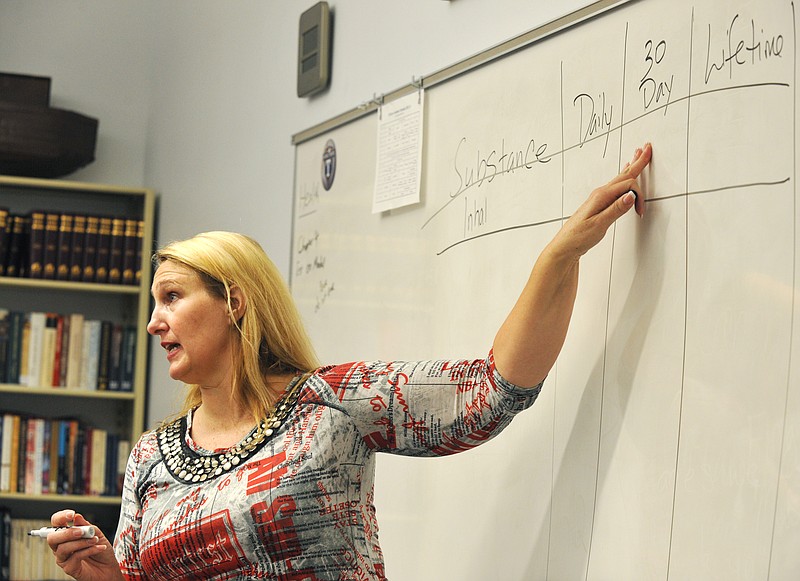 In this October 2012 photo, Joy Sweeney of the Council for Drug Free Youth asks students to fill in the blanks as they try to guess the percentage of students who admit to using drugs or alcohol in different time frames. Sweeney was at Calvary Lutheran High School for baseline training in an attempt to create awareness of the use of legal and illegal substances by Jefferson City area high school seniors. (News Tribune photo)