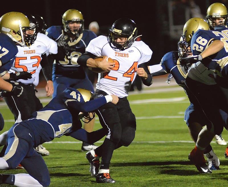 Helias' Shane Colonius grabs onto Kirksville's Scott Schwend in Class 4 District 6 play against Kirksville on Thursday night at Adkins Stadium.