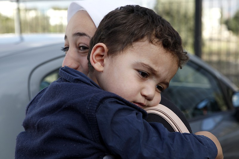 Bushr Al Tawashi is carried by his mothe,r Arin Al Dakkar, outside of a TV station Friday in Nicosia, Cyprus. A 2-year-old Syrian boy, who was believed dead after his family inadvertently left him behind as they fled shelling in Damascus last summer, has been reunited with his parents in Cyprus, a lawyer said.