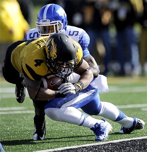 Missouri running back Kendial Lawrence, front, slips into the end zone past Kentucky safety Ashely Lowery for a touchdown during the first half of an NCAA college football game, Saturday, Oct. 27, 2012, in Columbia, Mo.