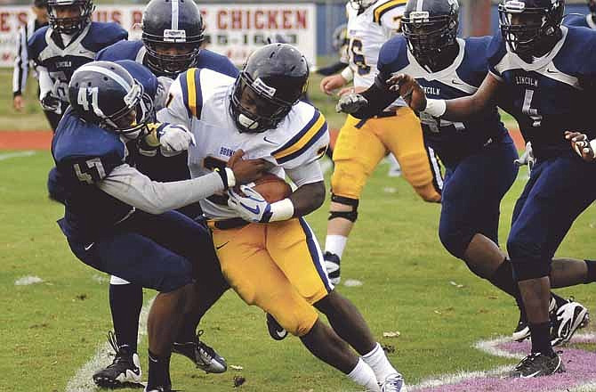 Keldon Warfield of Lincoln tries to bring down Joshua Birmingham of Central Oklahoma during Saturday's game at Dwight T. Reed Stadium in Jefferson City.