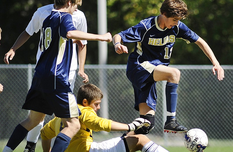 Helias midfielder Mark Mercurio tries to gather the loose ball after a blocked shot by Holt goalkeeper Sean Schierbecker during action earlier this year at the 179 Soccer Park. The Crusaders open Class 2 District 10 play today against Bolivar.