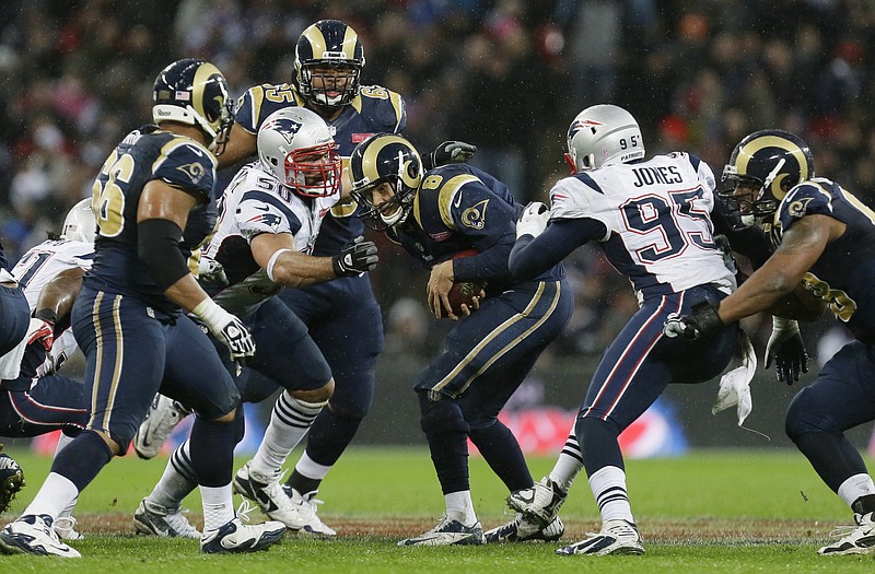 Rams quarterback Sam Bradford (8) gets sacked by Patriots defensive ends Chandler Jones (95) and Rob Ninkovich (50) during the second half Sunday at Wembley Stadium in London.