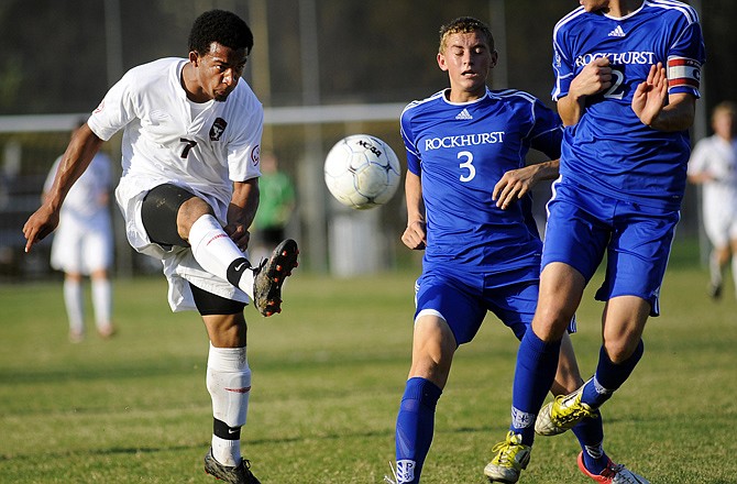 Jefferson City forward Marcus Woodruff fires a shot on goal around a pair of Rockhurst defenders in the first half of Wednesday's matchup at 179 Soccer Park.