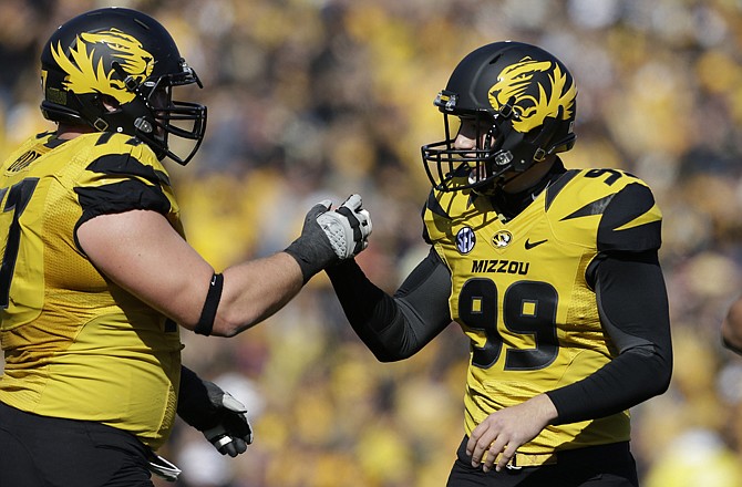 Missouri's Andrew Baggett (99) is congratulated by teammate Evan Boehm after after kicking a field goal during Saturday's game with Kentucky at Faurot Field.