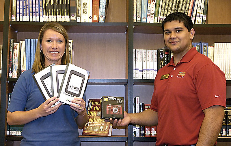 Three Nooks and a digital camera are shown by California High School Librarian Janet Henley, left, and local Sonic General Manager Jordan Wright. The new additions to the library are purchased through the "Limeades for Learning" program.    