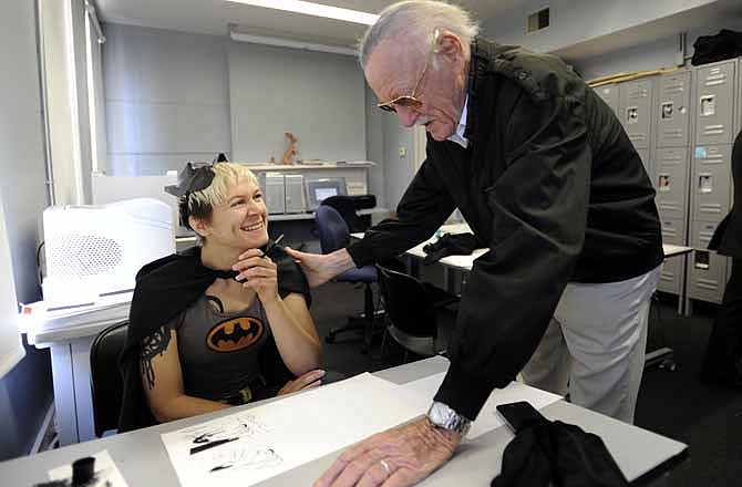 Legendary comic creator Stan Lee, right, looks over a drawing by Savannah College of Art and Design sequential art student Jen Hickman while visiting the college in Savannah, Ga., on Wednesday, Oct. 31, 2012. Lee, the 89-year-old co-creator of Spider-Man, dropped in on the school after being honored at the SCAD Savannah Film Festival.