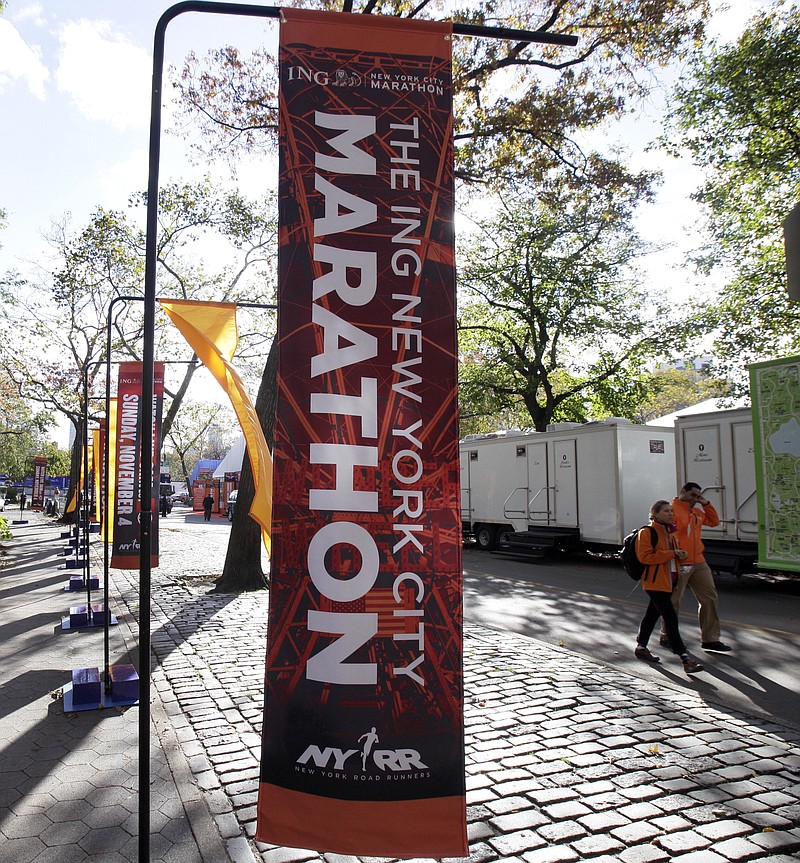 New York City Marathon banners adorn an entrance to New York's Central Park on Friday. Under growing pressure as thousands still shivered from Sandy, the marathon was canceled Friday by Mayor Michael Bloomberg.