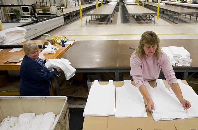 In this Monday, Oct. 15, 2012 photo, Judy Dross, left, and Gloria Bambrick count and stack components of T-shirts at FesslerUSA apparel manufacture in Orwigsburg, Pa. Family-owned FesslerUSA has survived war and depression, free trade and foreign imports to produce millions of knitted garments from its base in eastern Pennsylvania. Production will shut down in early November, tossing 130 employees out of work and ending a run of nearly 113 years. 