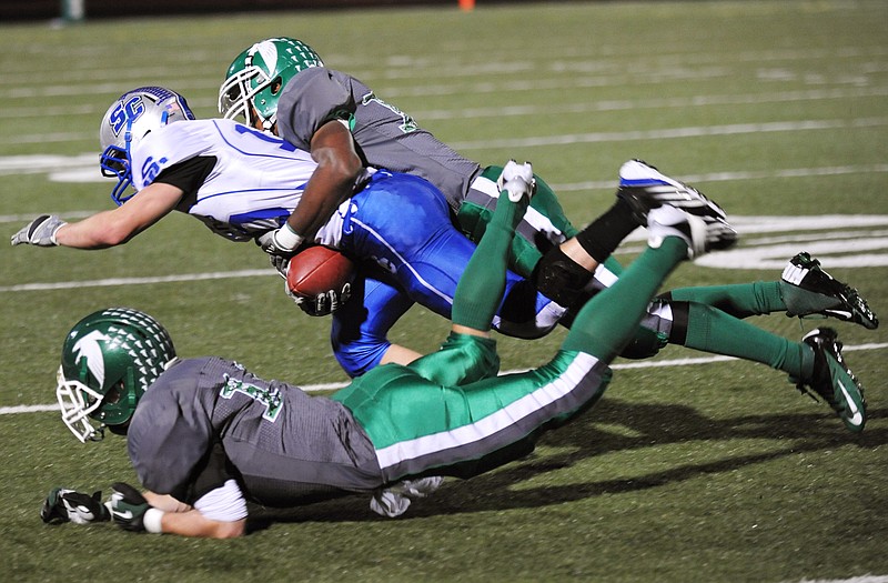 Blair Oaks' Dominic Jamerson brings down South Callaway's Cory Hanger on Monday at the Falcon Athletic Complex. In the foreground is Blair Oaks' Tyler Clutts.
