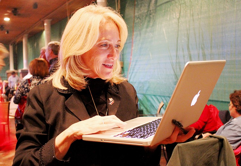 Rep. Jeanie Riddle, R-Mokane, checks election results Tuesday night on her computer during the Republican election watch rally in Fulton. Riddle easily defeated Democrat challerger Pam Murray of Holts Summit.