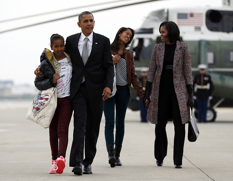 President Barack Obama, first lady Michelle Obama and their daughters Sasha and Malia, walk on Wednesday, Nov. 7, 2012, from Marine One to board Air Force One at Chicago O'Hare International Airport the day after his victory over Mitt Romney in the 2012 presidential election.